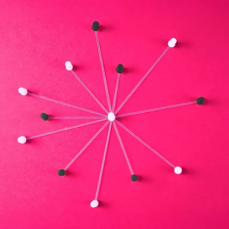 An abstract representation of a centralized network: a white pin at the center connects to multiple black and white pins around it using strings, symbolizing interconnected systems on a vibrant pink background.