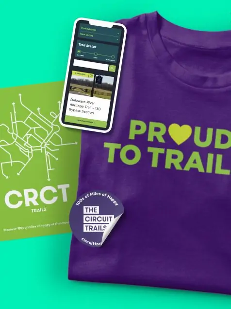 New branding and logo for Circuit Trails as shown on a t-shirt, hats, and print materials with the tagline 