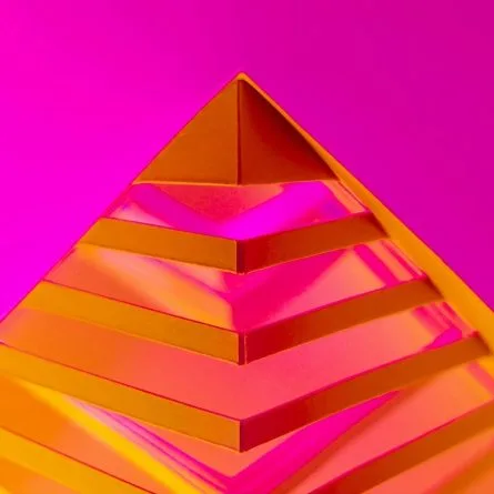 An eye-catching image featuring a bright magenta background with a 3D cut-out of an orange pyramid top in the foreground.
